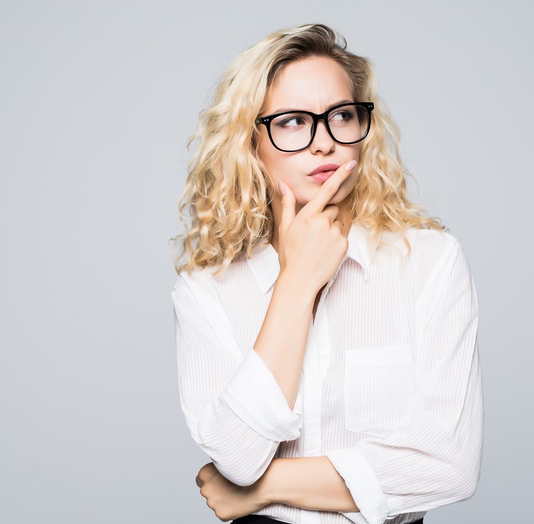 Beautiful thinking business woman isolated white background